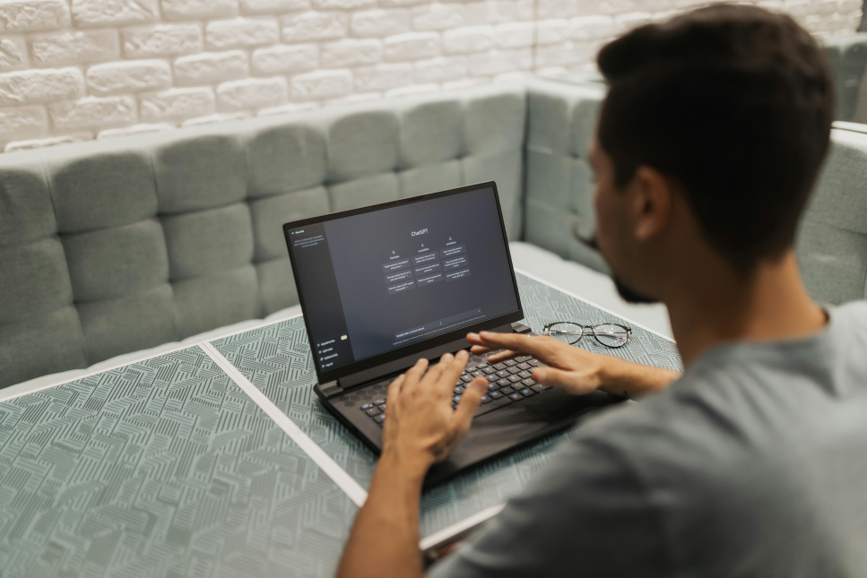 Man met laptop met daarop ChatGPT