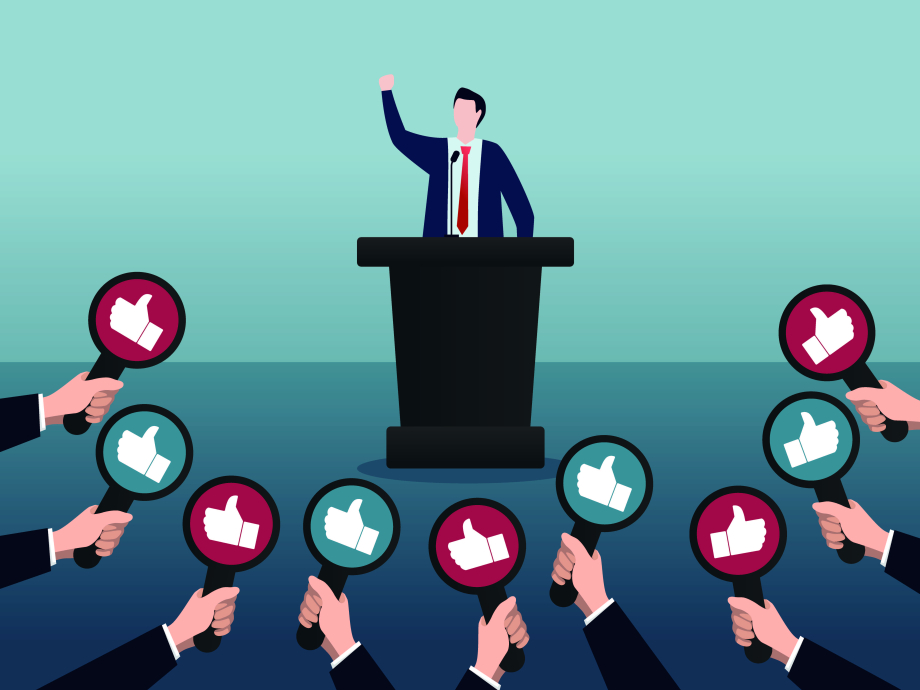 Een speechende politicus die allemaal 'duimpjes' krijgt 