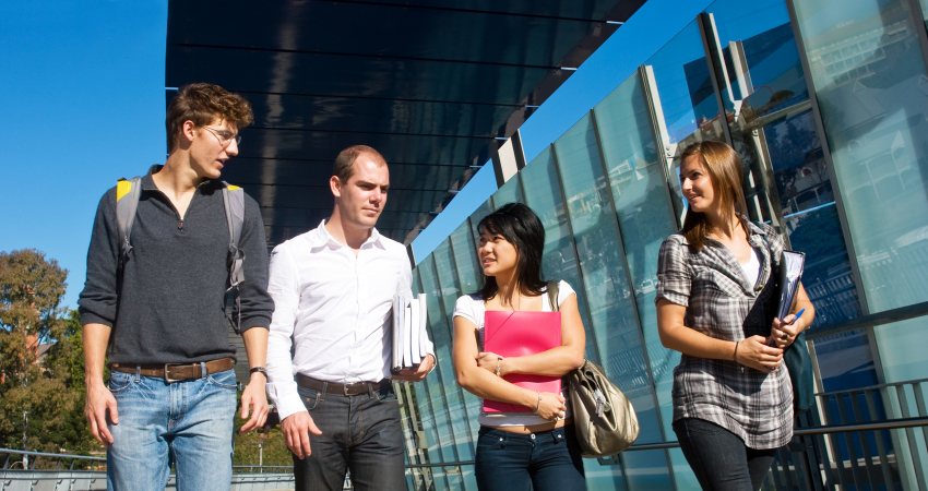Vier onderzoekers lopen bij de High Tech Campus Eindhoven