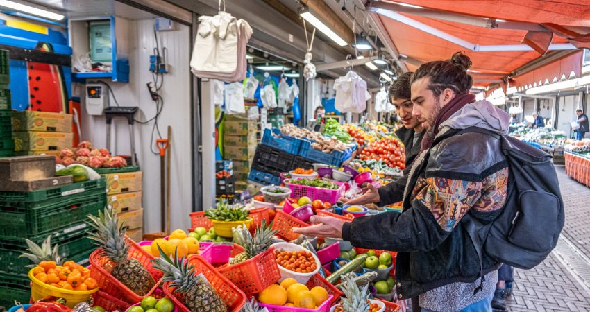 Two men buying fruit at the market in The Hague