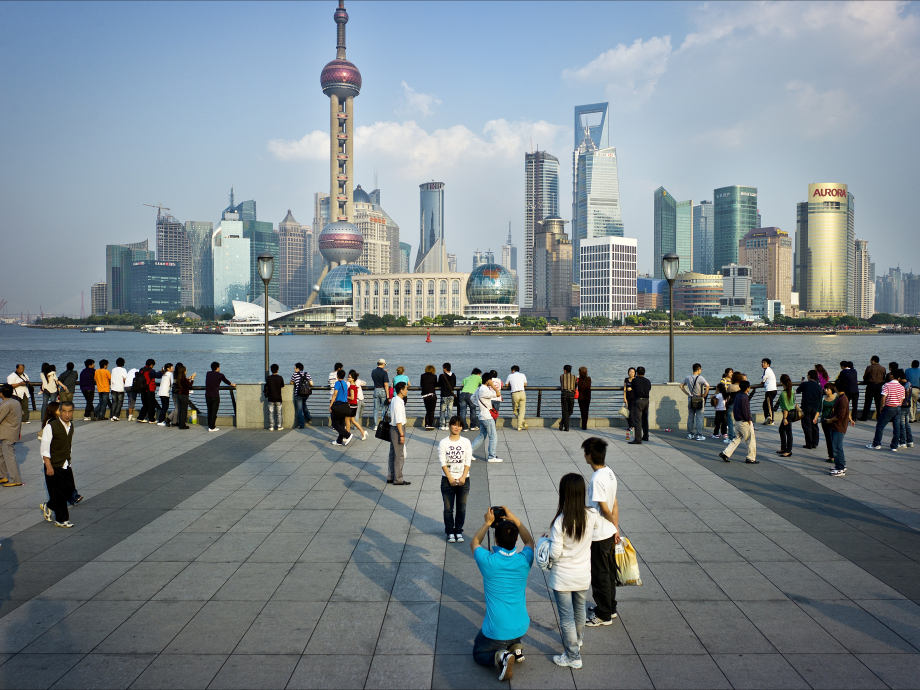 Toeristen poseren voorde  skyline van Shanghai