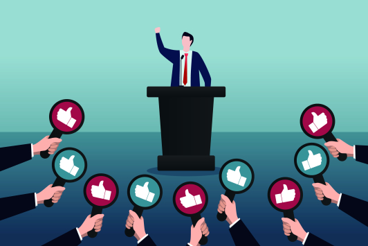 Een speechende politicus die allemaal 'duimpjes' krijgt 