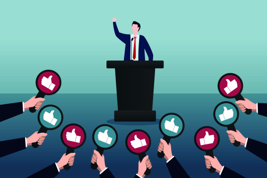 Een speechende politicus die allemaal 'duimpjes' krijgt 